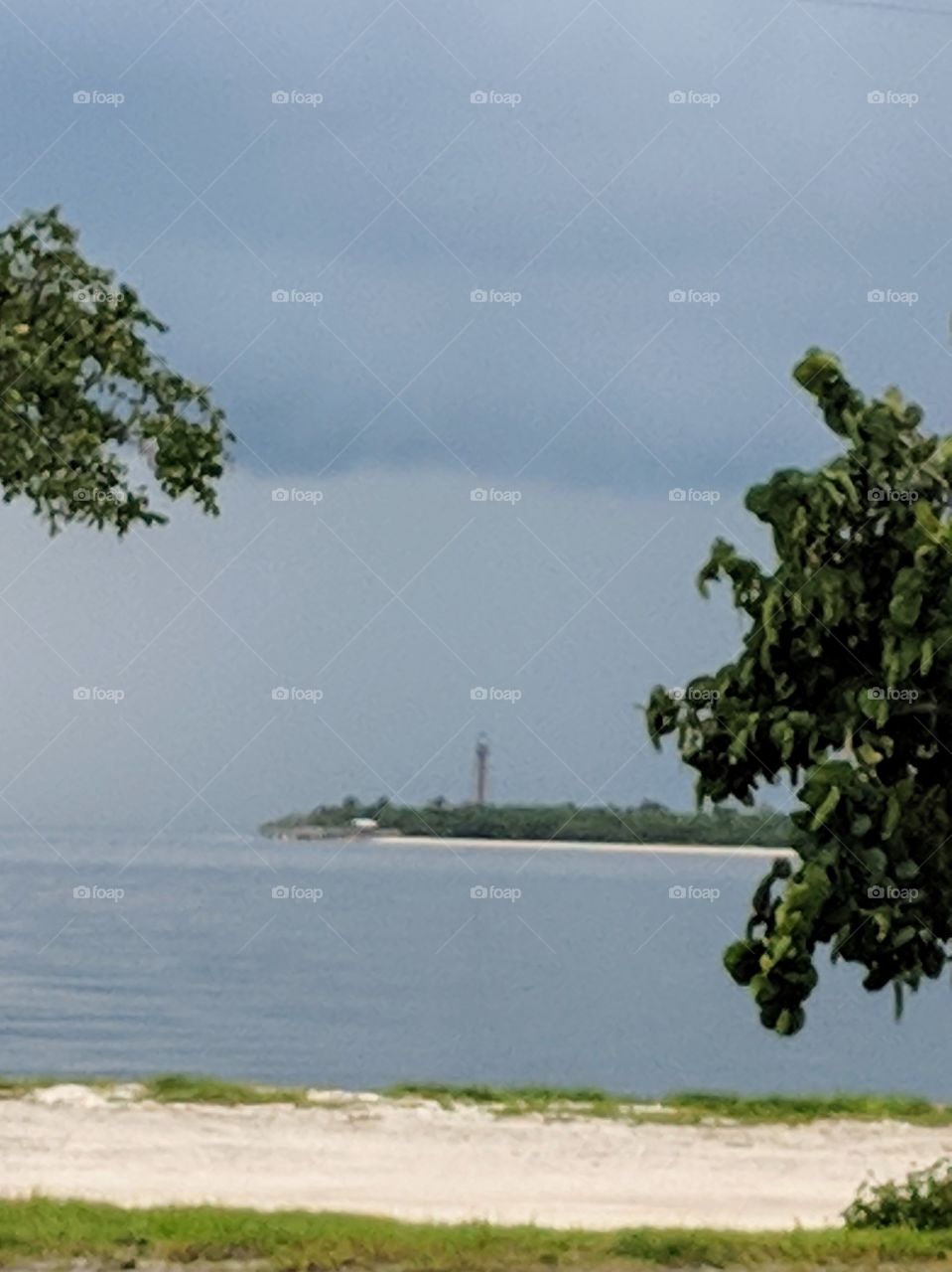 A storm rolls in over the Sanibel Island Lighthouse; photo taken from a pull off on the Sanibel causeway, FL.