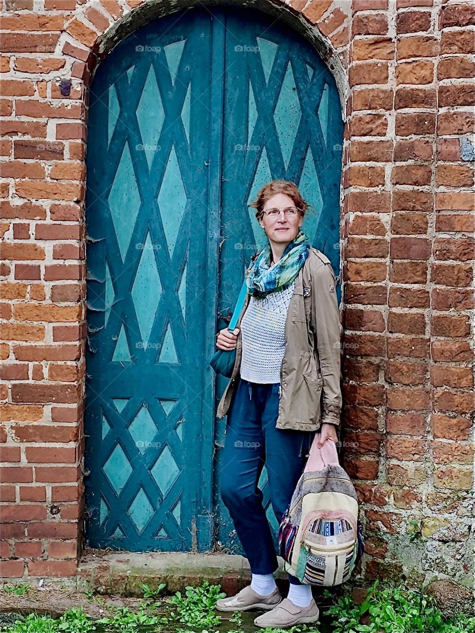 This traveling lady is standing by the entrance to “St George” church in “Wiek”, “Mecklenburg - Western Pomerania”, Germany. 2024. Hypnotic Productions