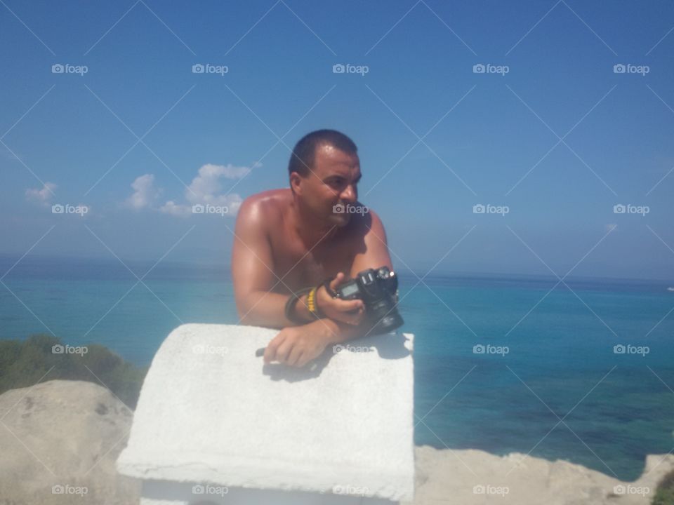 Man with camera on the beach