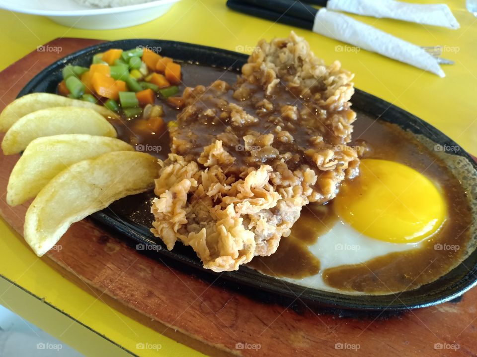 chicken steak for dinner with egg and potatoes.