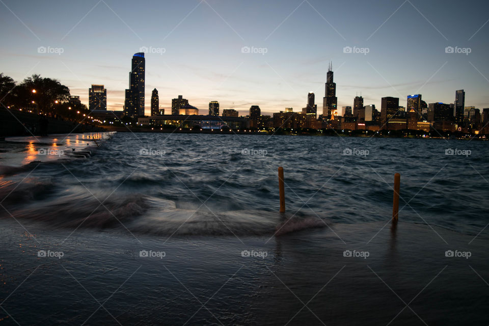 Waves crashing over boardwalk, downtown Chicago. 