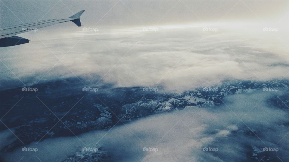 above the clouds. above the alps flying back home