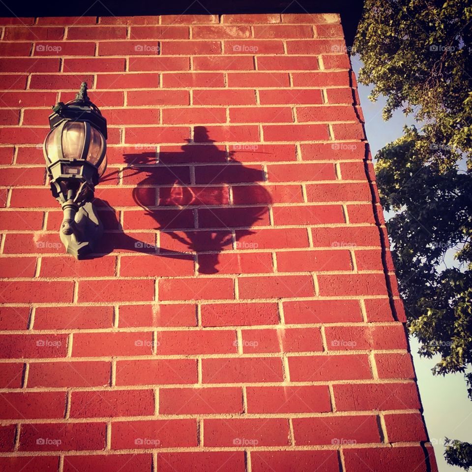 Antique Lamp on Brick Wall at Sunset