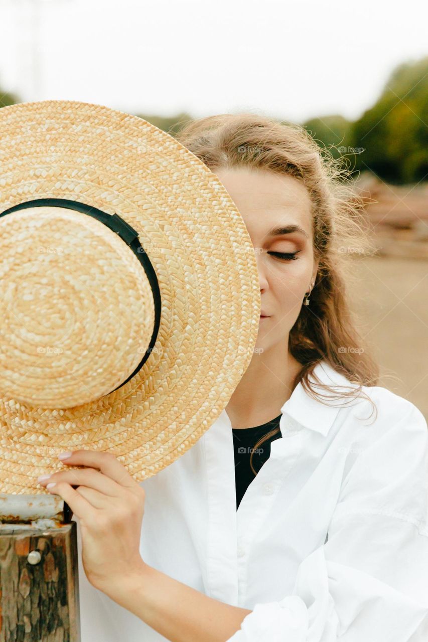 Girl with yellow hat close eyes