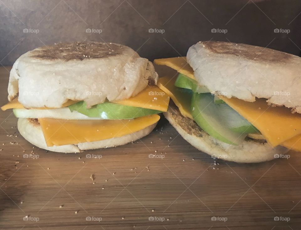 An apple and cheese melt sandwich on English muffins on display on the cutting board in the kitchen. USA, America 