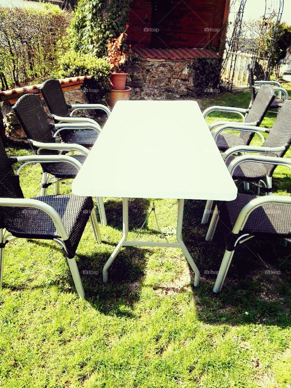 garden table with chairs on green grass