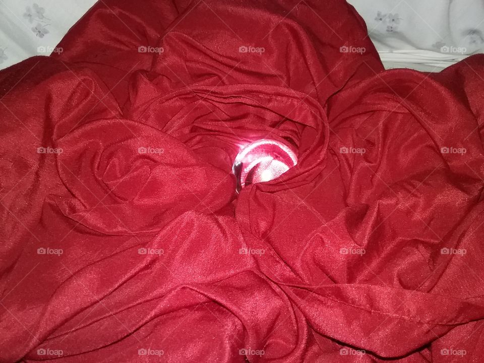 Glowing glass orb on red cloth.