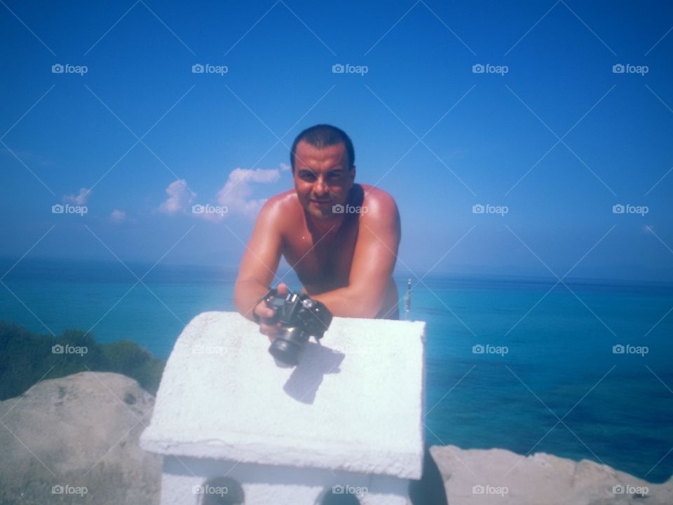 Man with camera on the beach