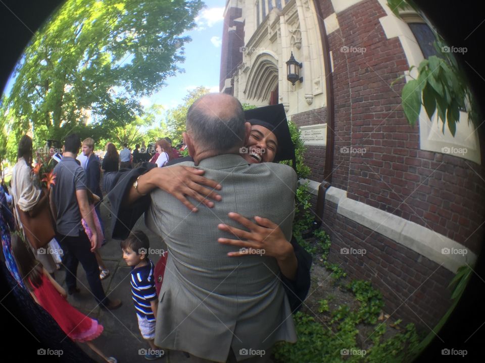 Grandpa Hugs His College Graduate