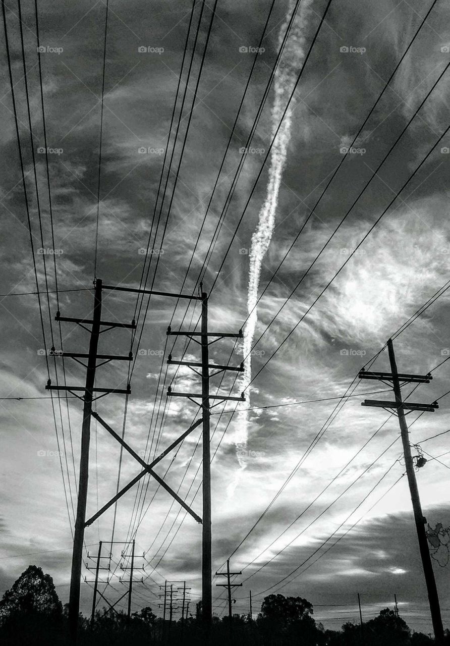 Electricity and electric poles in a beautiful storm with chemtrials