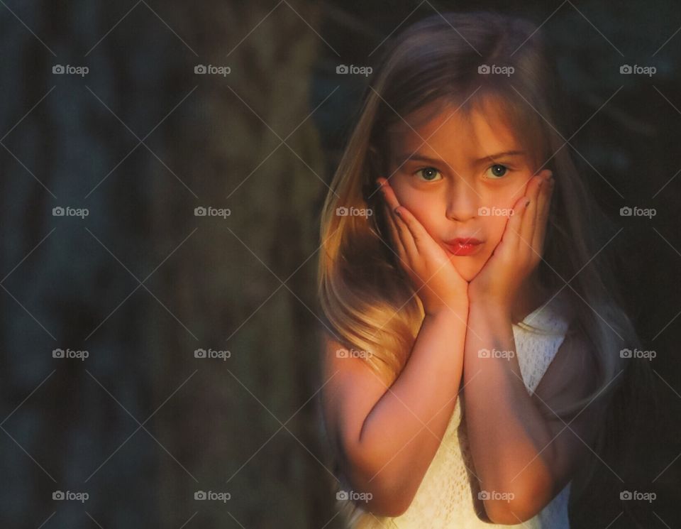 Little girl playing in the orange light of a sunset
