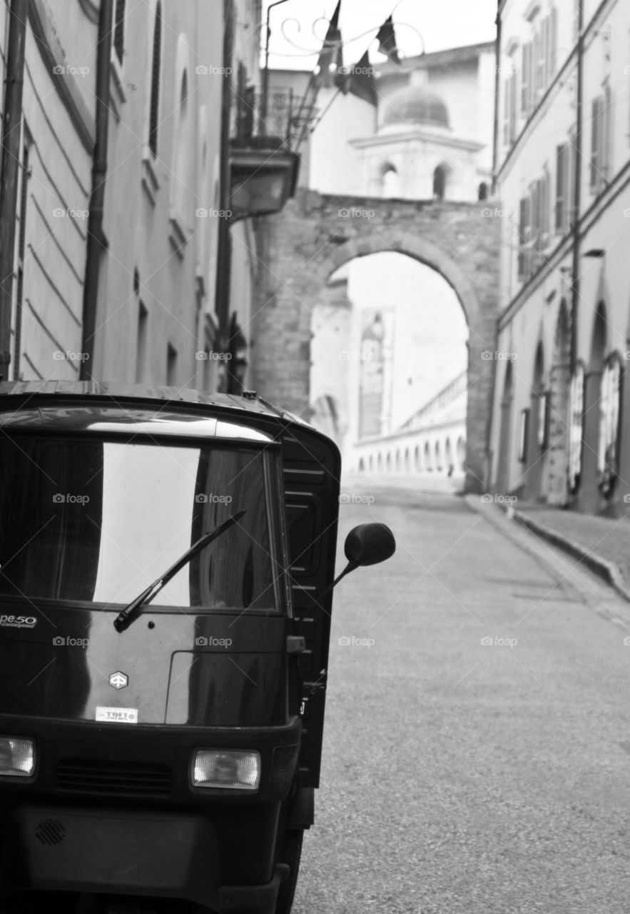 Small delivery car parked on an Italian city street 