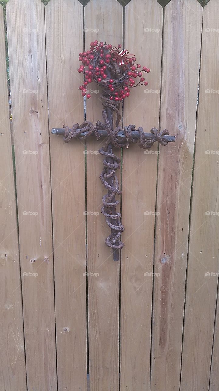 berry cross. this cross has a live vine growing around it