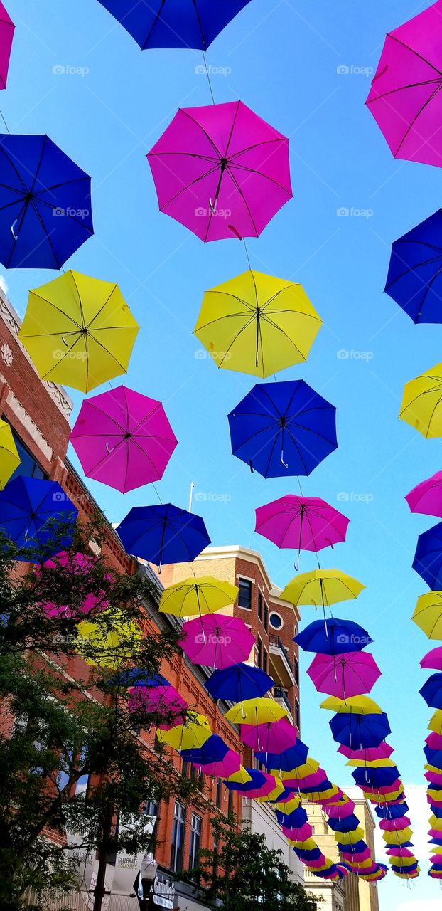 Colorful Umbrellas and brick Building in City Center