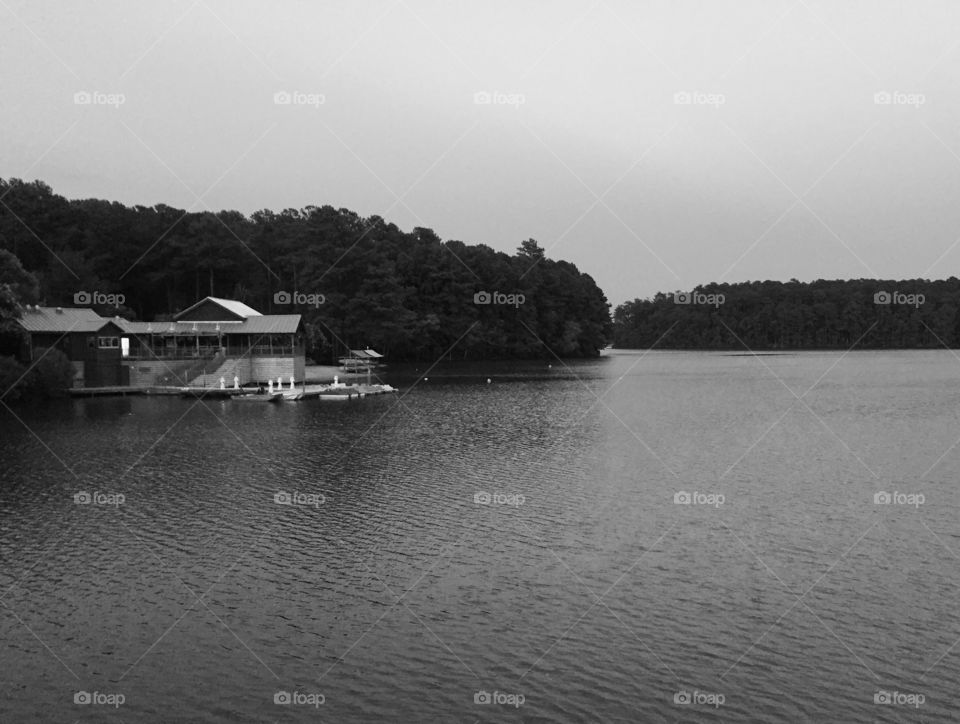 Black and white picture of a lake and building 