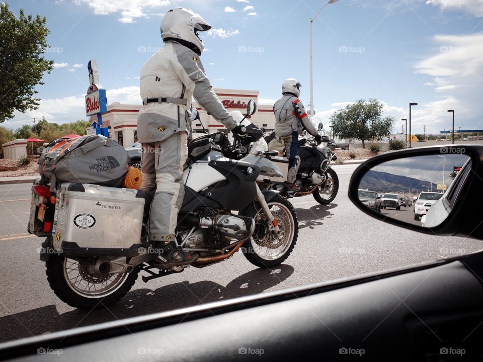 Motorcycle riders stuck in traffic.