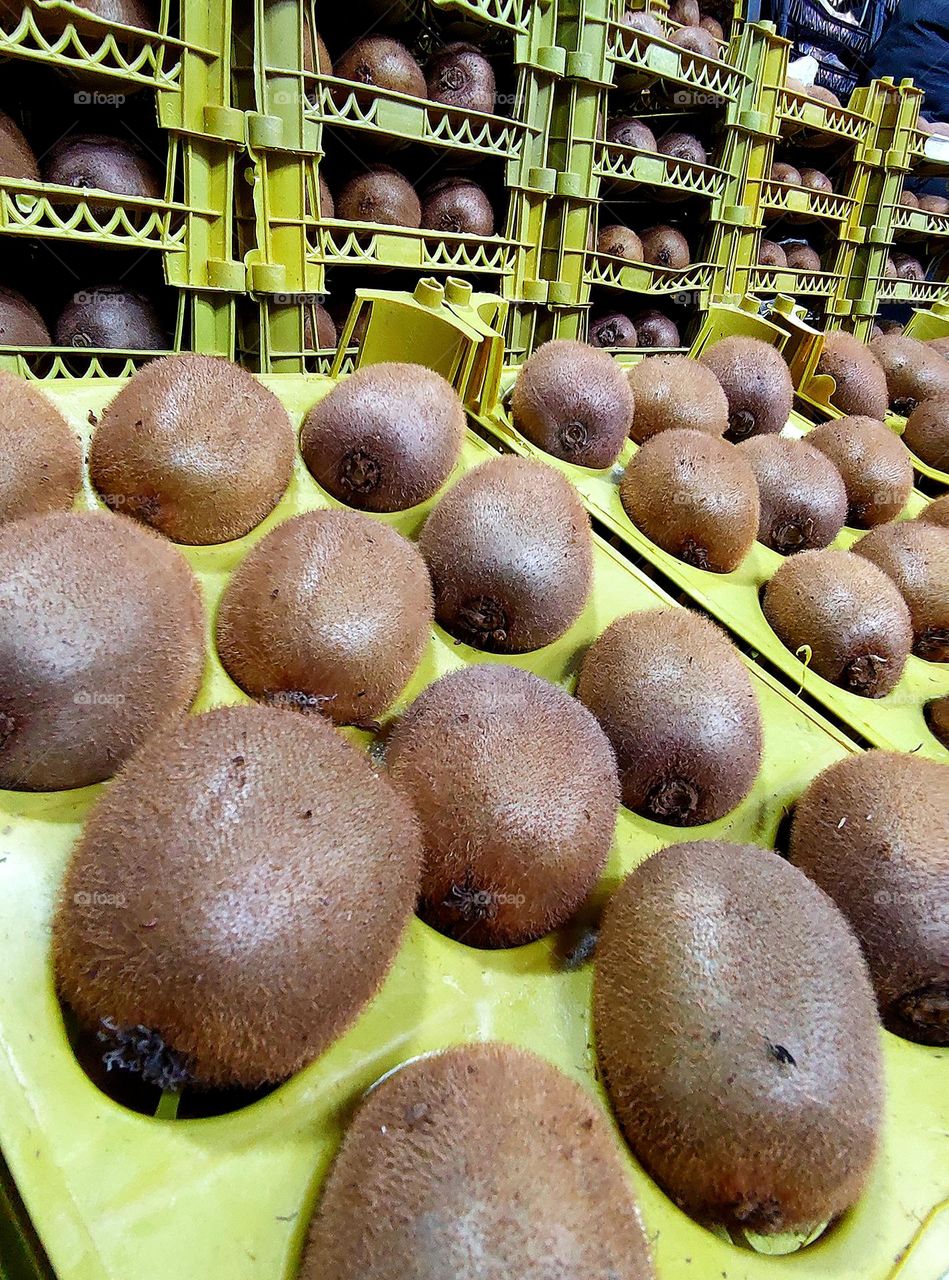 Spring market.  Boxes with fresh kiwi fruit