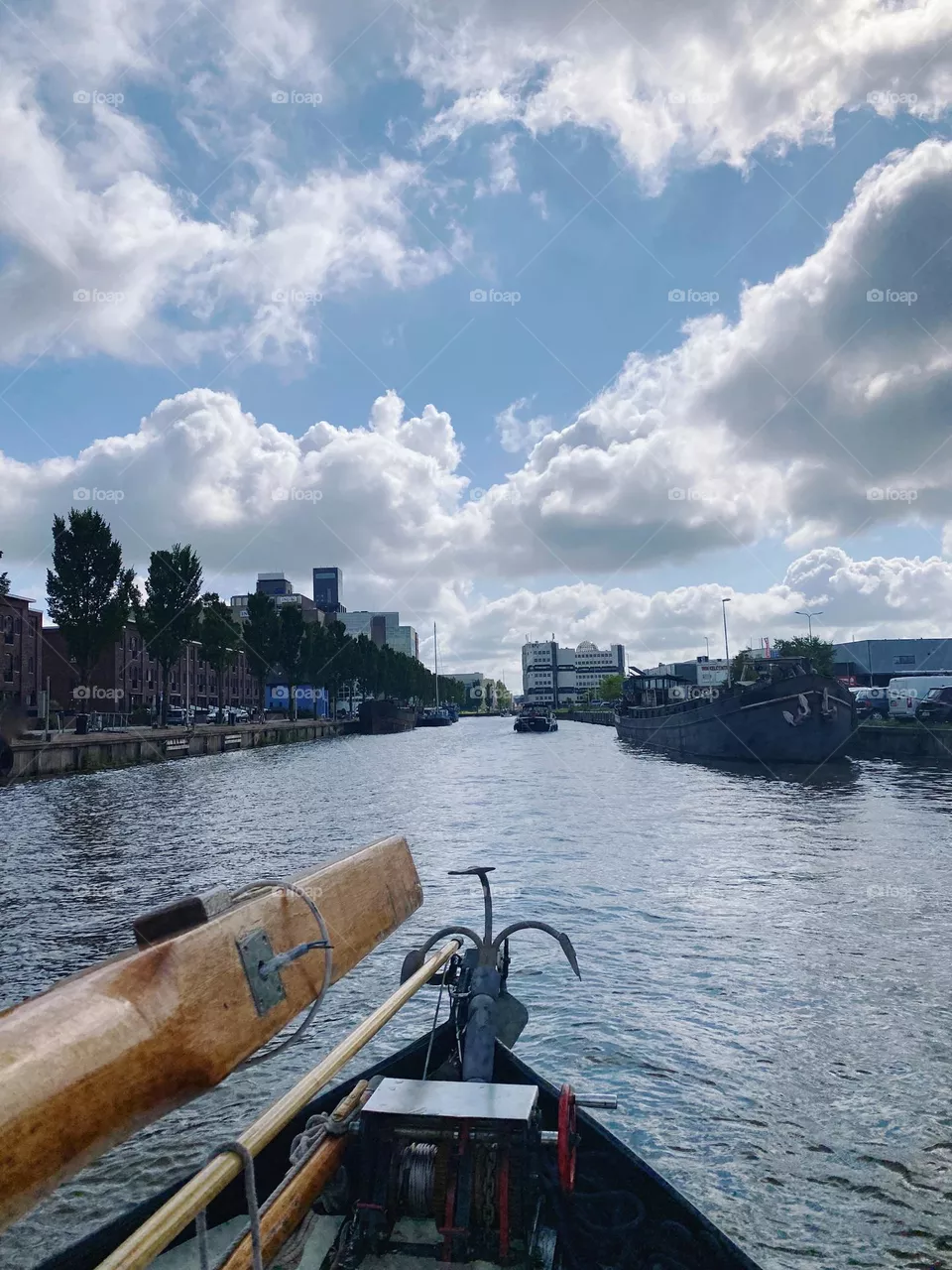 On our boat in the north of Holland! Massive clouds, blue sky. Nature, summer. View from the boat