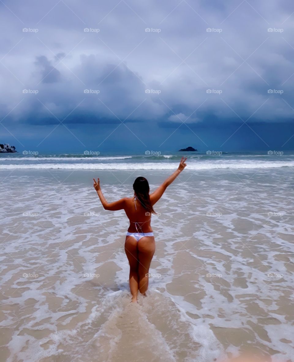 woman from the back enjoying the beach joy