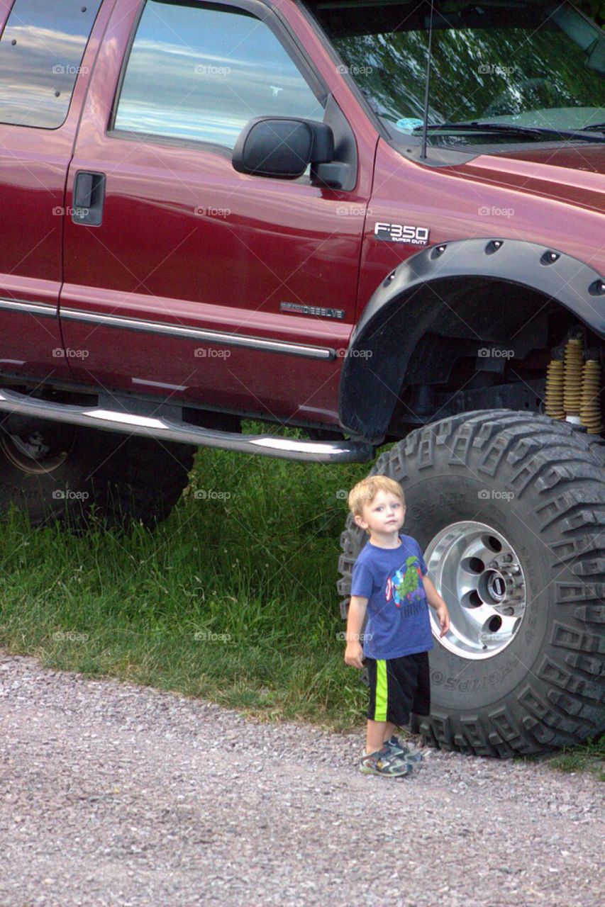 Boy standing near the car