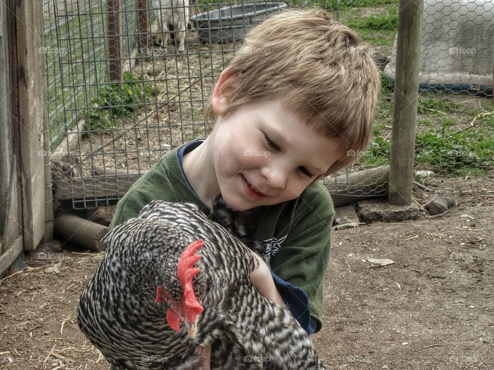 Boy Holding a Chicken 