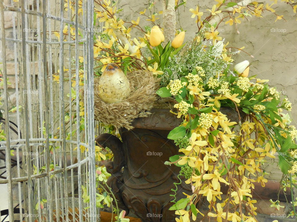 Yellow floral decor with bird pot and cage