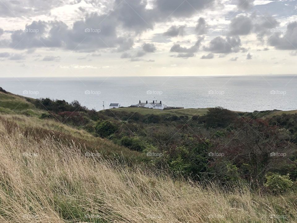 White house between sea and fields