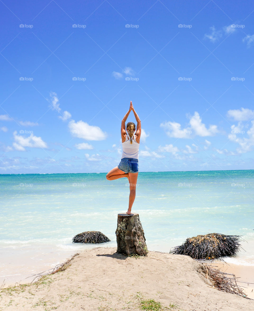 Doing yoga on the beach