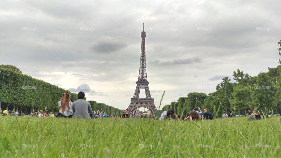 Eiffeltower Paris from Lawn with people recreating