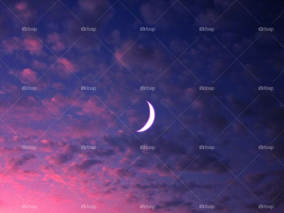 Pink sunset,  clouds and the moon at Naples ( Italy ).