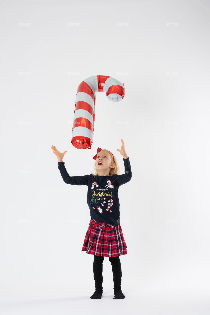 Young girl playing with balloon