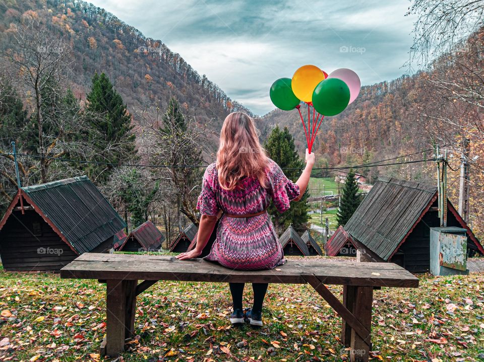 Girl alone with balloons