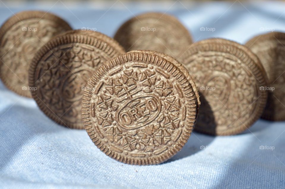 Oreo cookies standing on a blue background