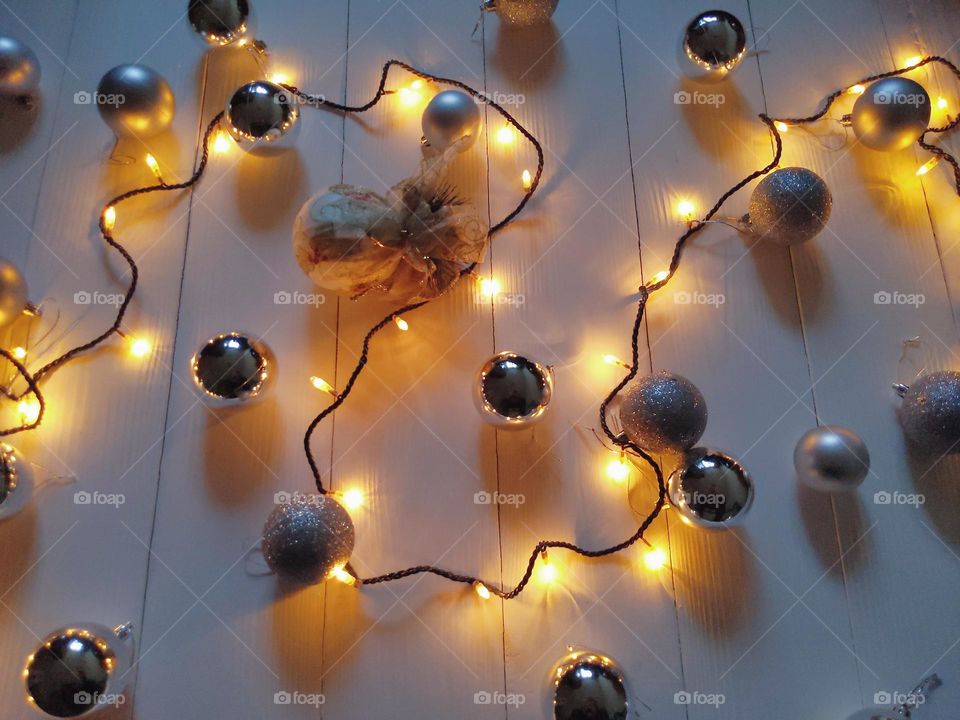 Christmas glowing garland and silver Christmas balls on a white background