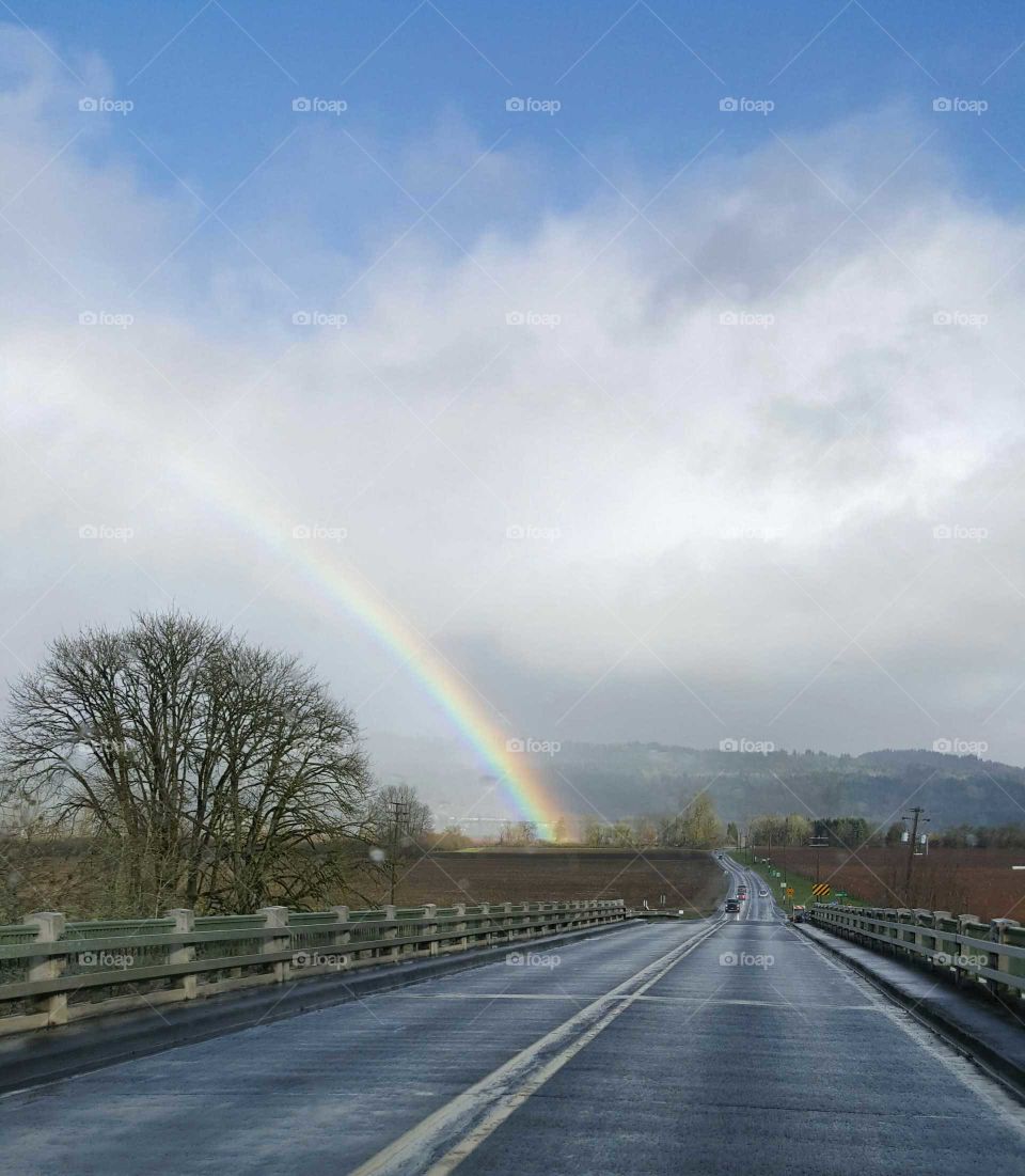 rainbow, clouds, trees, farm, fields, sky, road, fence, hills, blue, winter