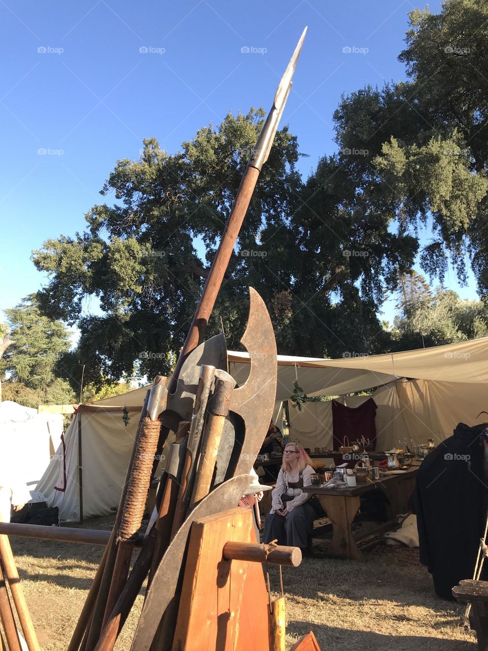 Battle-ready bladed weapons displayed on a rack in camp during the the Renaissance Faire at Kearney Park. They belong to an Irish guild that utilizes them for martial skills demonstrations and battle re-enactments.