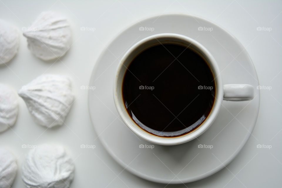 coffee cup with candy top view on a white background