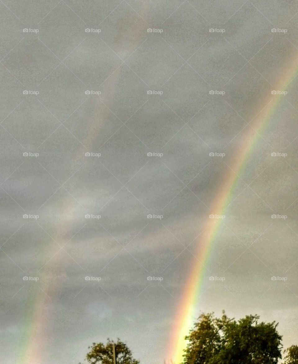 Double rainbow from ground to clouds