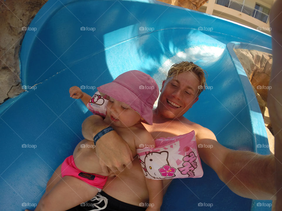 Father and doughter riding the waterslide at their holiday in Alcudia on Majorca. (Picture taken with GoPro camera.)