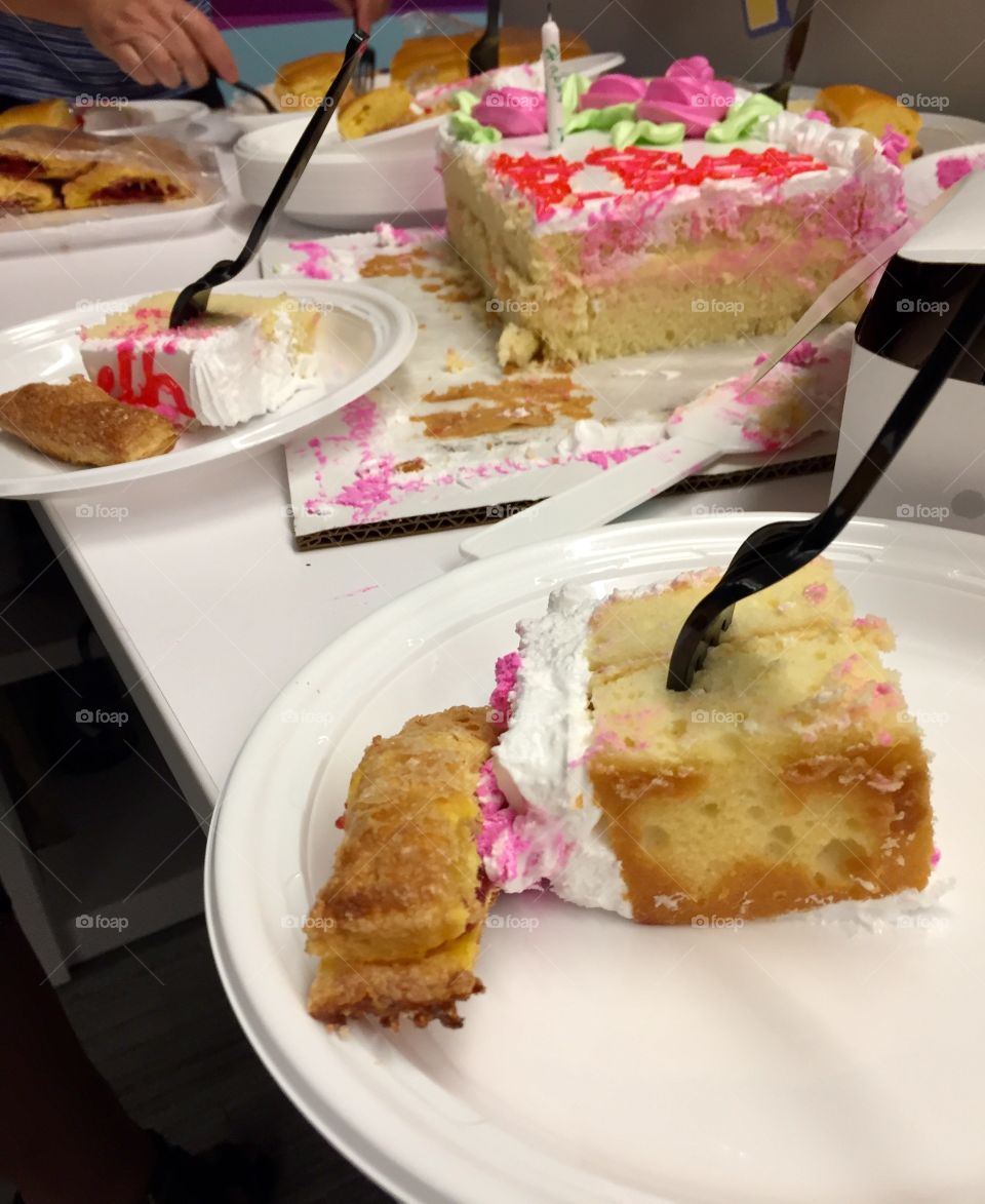 Plates with birthday cake and pastries
