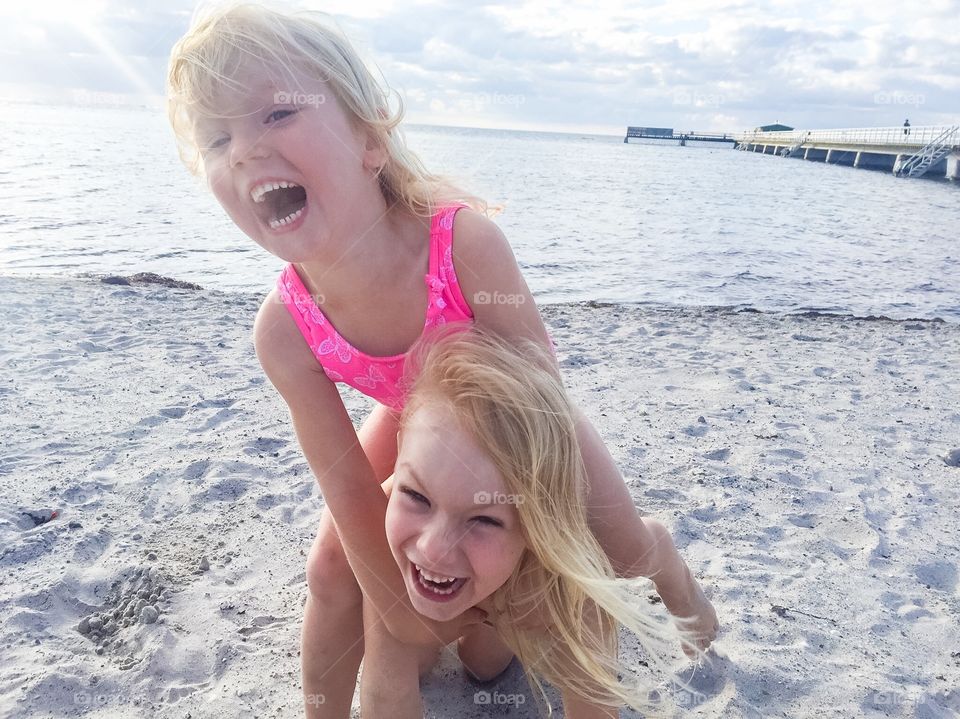 Two sisters are playing on Ribban beach in Malmö Sweden.