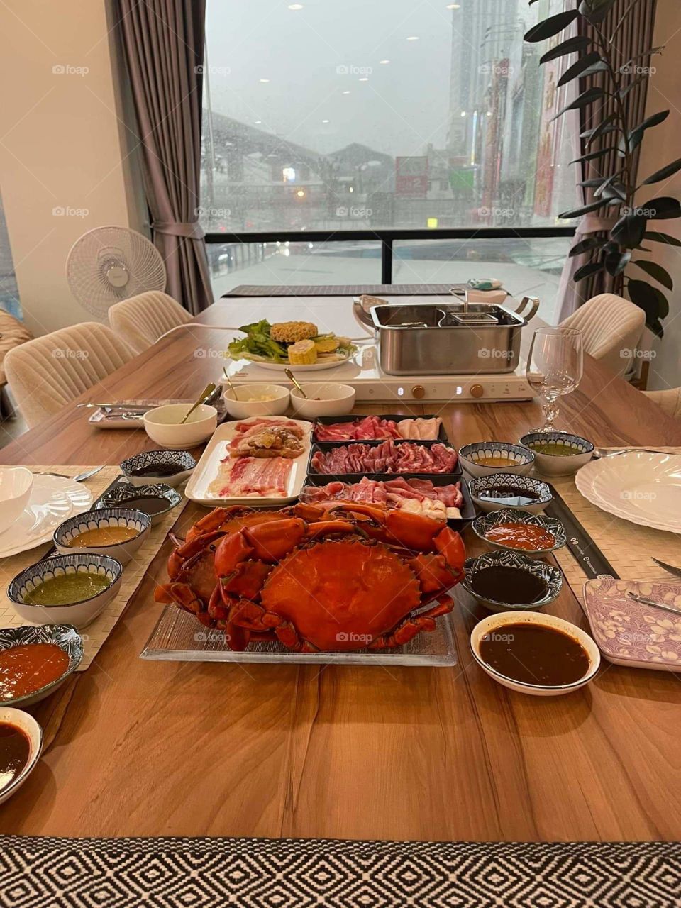 Seafood with big crabs on a wooden table by the window