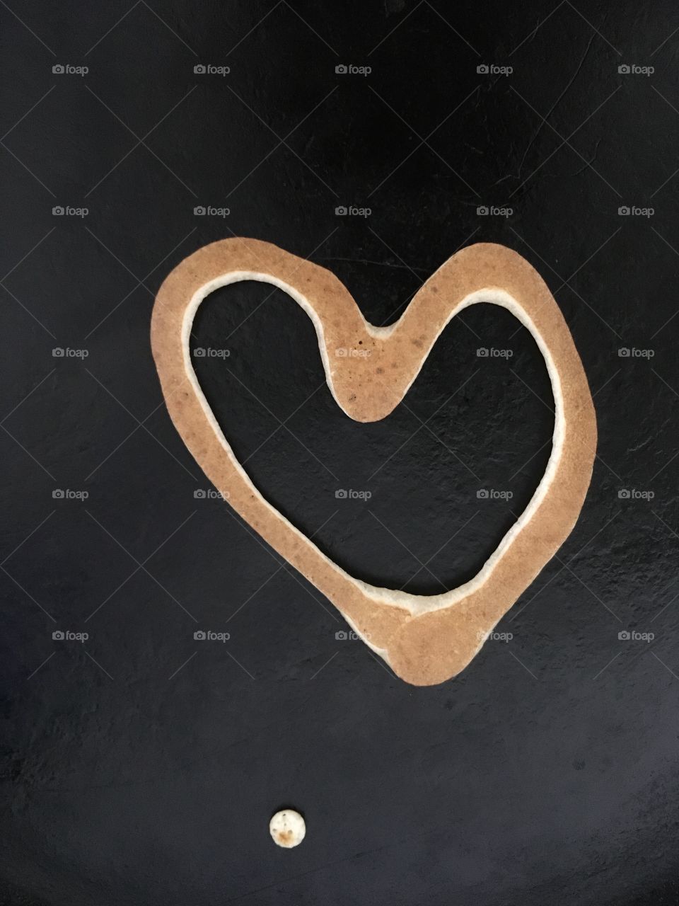 Pancake heart on black background