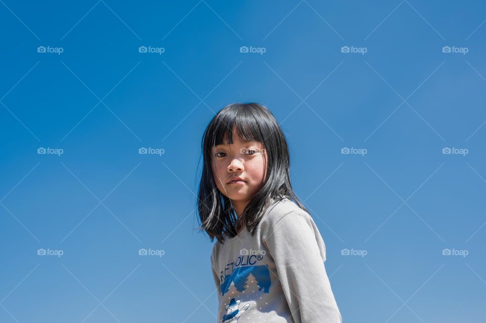 A simple portrait shot of my daughter in the open, I choose this photo because of the innocent emotion reflecting in her eyes.