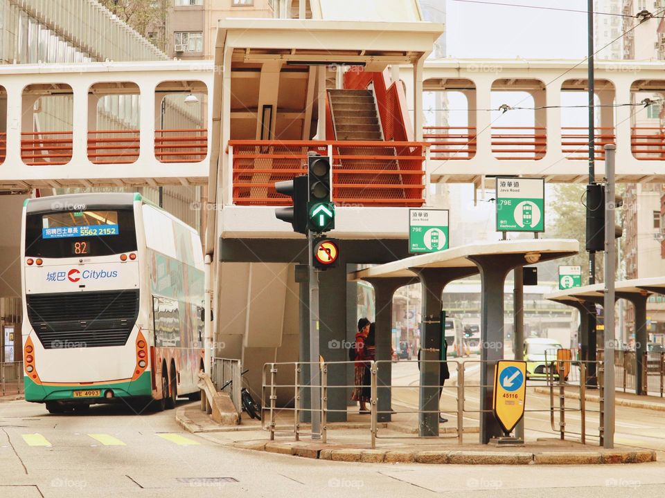 a bus stop with a pedestrian bridge