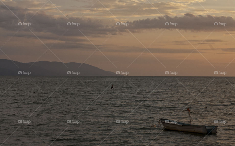 A lone paddle boarder at sunset just off the Malecon in Puerto Vallarta.