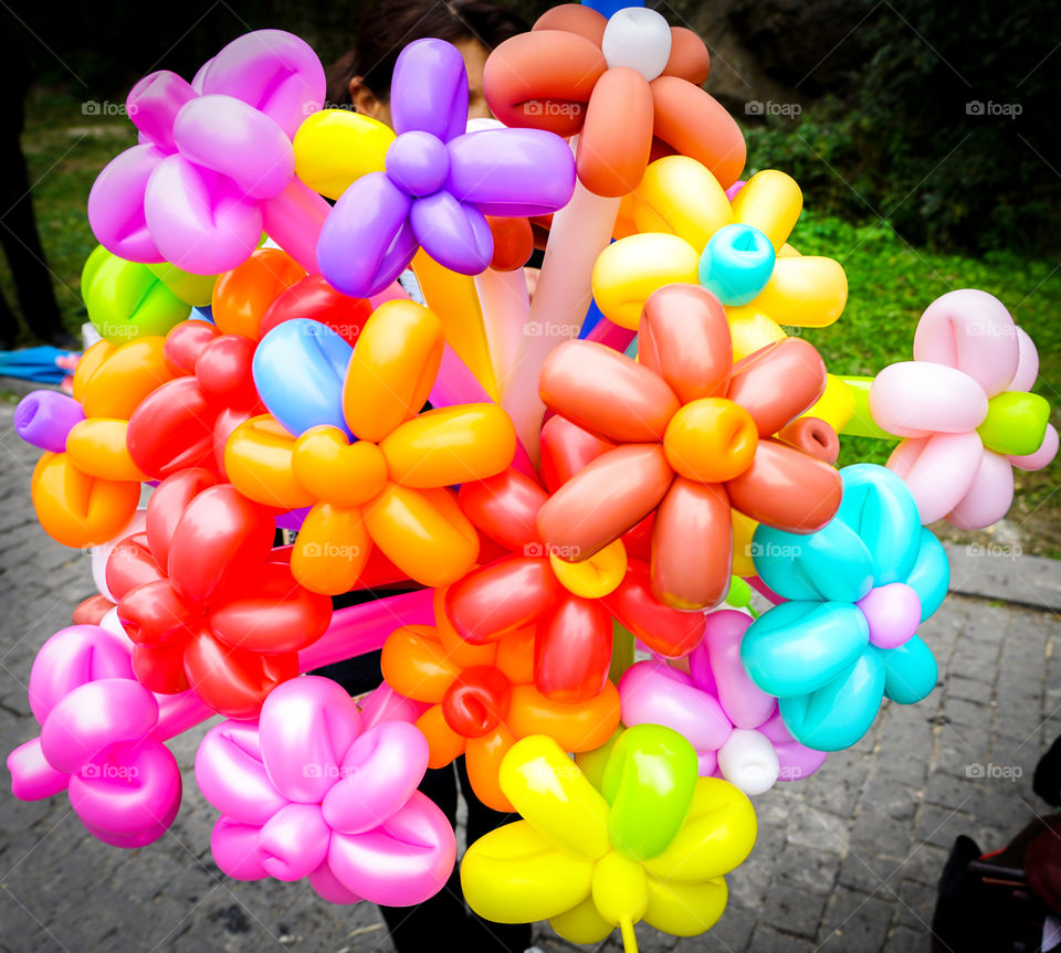 big bunch of colorful balloons in form of flowers on the streetmarket