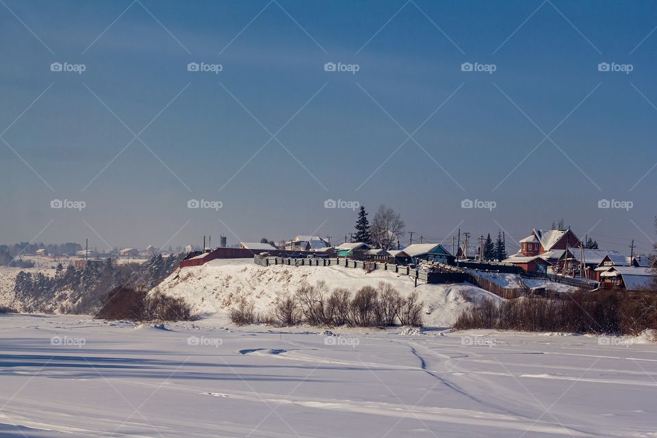 At home against a backdrop of snow-covered fields.