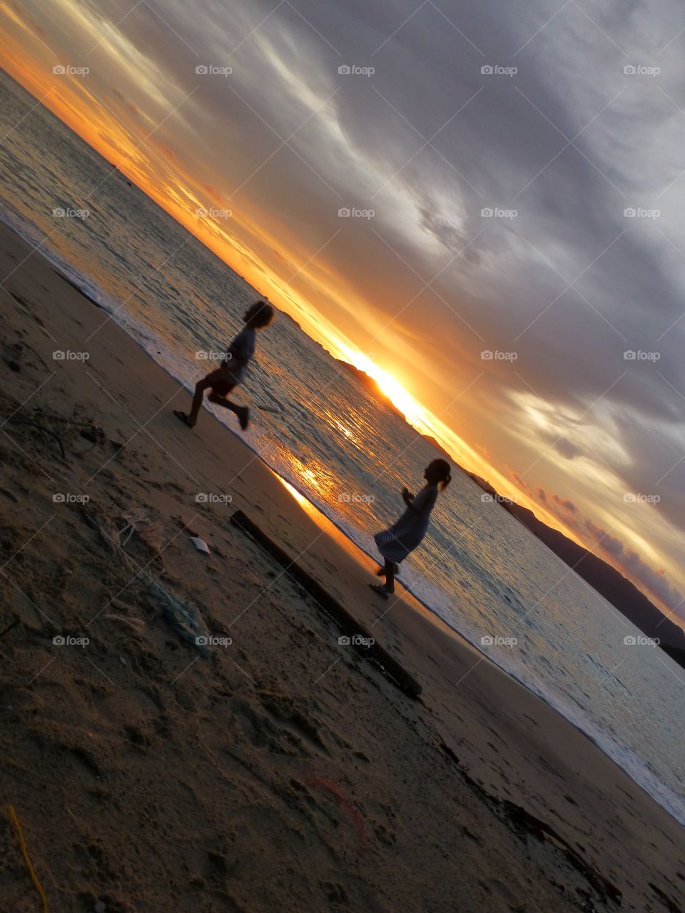 Running on the beach. Sunset and happy kids