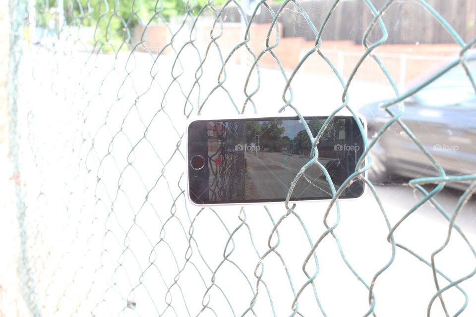 iPhone in chain linked fence time lapse 